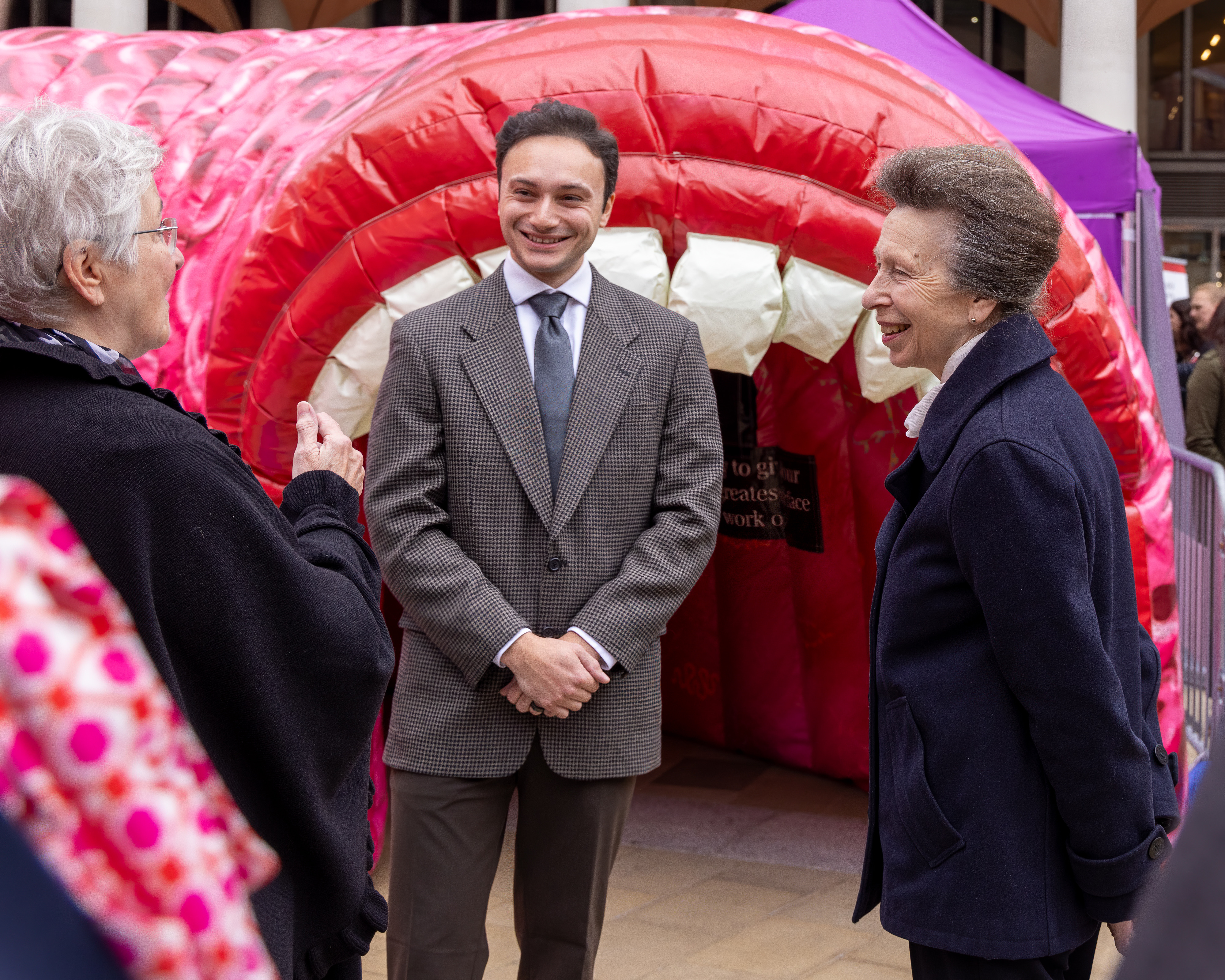 Luca Cuccia with HRH The Princess Royal at the Inside Out Festival, London, in front of an inflatable GI tract